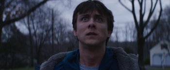 Movie still from “Super Dark Times” (2017), directed by Kevin Phillips – A young man looking up into the sky; Close Up shot, Low angle