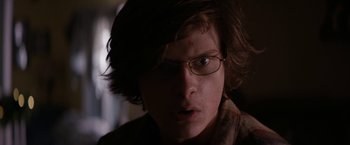 Movie still from “Super Dark Times” (2017), directed by Kevin Phillips – A young man with glasses is looking at the camera; Close Up shot, Over the shoulder angle