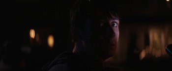 Movie still from “Super Dark Times” (2017), directed by Kevin Phillips – A man is looking into the distance in the dark; Close Up shot, Over the shoulder angle