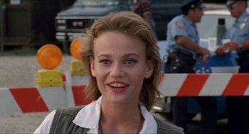 Movie still from “Super Mario Bros.” (1993), directed by Annabel Jankel – A person smiling for the camera; Close Up shot, Over the shoulder angle