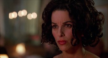 Movie still from “Super Mario Bros.” (1993), directed by Annabel Jankel – A person wearing a necklace; Close Up shot, Over the shoulder angle