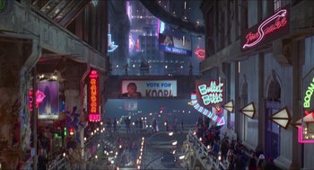 Movie still from “Super Mario Bros.” (1993), directed by Annabel Jankel – People are walking through a city at night; Extreme Wide shot, High angle