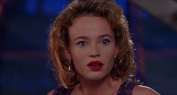 Movie still from “Super Mario Bros.” (1993), directed by Annabel Jankel – A person wearing a purple dress; Close Up shot, Over the shoulder angle