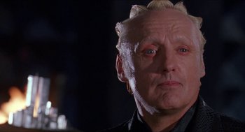 Movie still from “Super Mario Bros.” (1993), directed by Annabel Jankel – An older man with a shaved head and a goatee; Close Up shot, Low angle