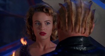 Movie still from “Super Mario Bros.” (1993), directed by Annabel Jankel – A woman with red lipstick looking into a mirror; Close Up shot, Over the shoulder angle