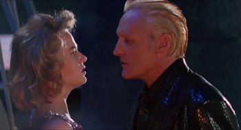 Movie still from “Super Mario Bros.” (1993), directed by Annabel Jankel – A man and a woman face to face in front of a dark background; Close Up shot, Low angle