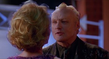 Movie still from “Super Mario Bros.” (1993), directed by Annabel Jankel – An older man and a younger woman are talking to each other; Close Up shot, Over the shoulder angle