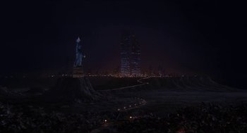 Movie still from “Super Mario Bros.” (1993), directed by Annabel Jankel – The statue of liberty is lit up at night; Extreme Wide shot, High angle