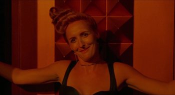 Movie still from “Super Mario Bros.” (1993), directed by Annabel Jankel – A woman in a black top is posing for a picture; Close Up shot, Low angle