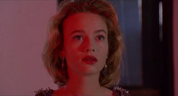 Movie still from “Super Mario Bros.” (1993), directed by Annabel Jankel – A young woman with blonde ringlet hair wearing a purple dress; Close Up shot, Low angle