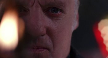 Movie still from “Super Mario Bros.” (1993), directed by Annabel Jankel – An older man with a blue eye stares at the camera; Extreme Close Up shot, Low angle