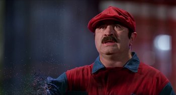 Movie still from “Super Mario Bros.” (1993), directed by Annabel Jankel – A man with a mustache wearing a red hat; Close Up shot, Low angle