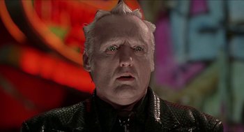 Movie still from “Super Mario Bros.” (1993), directed by Annabel Jankel – An older man with white hair wearing a leather jacket; Close Up shot, Low angle