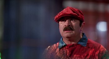 Movie still from “Super Mario Bros.” (1993), directed by Annabel Jankel – A man in a red hat and a red shirt; Close Up shot, Low angle
