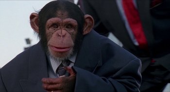 Movie still from “Super Mario Bros.” (1993), directed by Annabel Jankel – A chimpanzee that is wearing a suit and tie; Close Up shot, Low angle