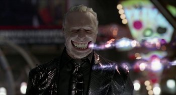 Movie still from “Super Mario Bros.” (1993), directed by Annabel Jankel – A man's face in a suit and tie; Close Up shot, Low angle