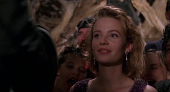 Movie still from “Super Mario Bros.” (1993), directed by Annabel Jankel – A young woman is looking up at the sky; Close Up shot, Over the shoulder angle