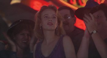 Movie still from “Super Mario Bros.” (1993), directed by Annabel Jankel – A woman in a purple dress looking up at a neon sign; Close Up shot, Low angle
