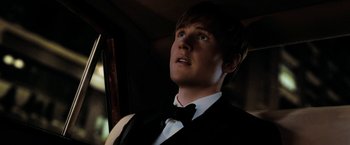 Movie still from “Surrogates” (2009), directed by Jonathan Mostow – A young man in a black vest and a bow tie; Close Up shot, Low angle