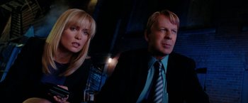 Movie still from “Surrogates” (2009), directed by Jonathan Mostow – A man and a woman in a suit and tie; Close Up shot, Low angle