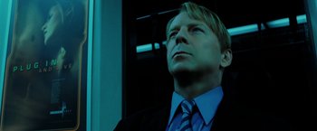 Movie still from “Surrogates” (2009), directed by Jonathan Mostow – A person wearing a suit and tie; Close Up shot, Low angle