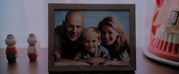 Movie still from “Surrogates” (2009), directed by Jonathan Mostow – A picture of a man , woman , and a child; Extreme Close Up shot, Overhead angle