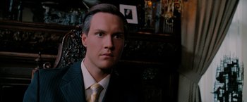 Movie still from “Surrogates” (2009), directed by Jonathan Mostow – A person wearing a suit and tie; Close Up shot, Low angle