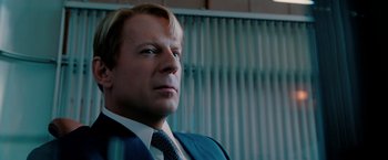 Movie still from “Surrogates” (2009), directed by Jonathan Mostow – A person wearing a suit and tie; Close Up shot, Low angle