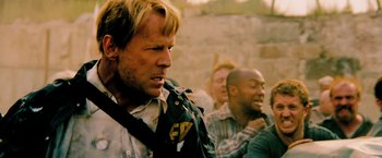 Movie still from “Surrogates” (2009), directed by Jonathan Mostow – A group of men standing next to each other; Close Up shot, Over the shoulder angle