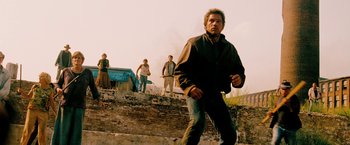 Movie still from “Surrogates” (2009), directed by Jonathan Mostow – A group of people standing on top of a brick wall; Wide shot, Low angle