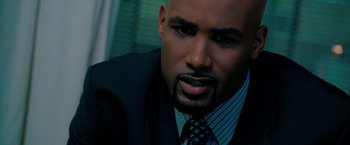 Movie still from “Surrogates” (2009), directed by Jonathan Mostow – A person wearing a suit and tie; Close Up shot, High angle