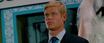 Movie still from “Surrogates” (2009), directed by Jonathan Mostow – A man with blonde hair wearing a suit and tie; Close Up shot, Low angle
