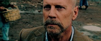 Movie still from “Surrogates” (2009), directed by Jonathan Mostow – A person wearing a suit and a beard; Close Up shot, Over the shoulder angle