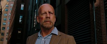 Movie still from “Surrogates” (2009), directed by Jonathan Mostow – A bald man with blood on his face and chest; Close Up shot, Low angle