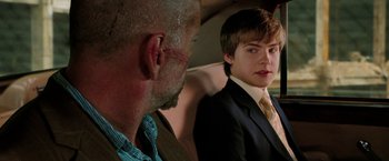 Movie still from “Surrogates” (2009), directed by Jonathan Mostow – A man and a young boy in a suit and tie; Close Up shot, Over the shoulder angle