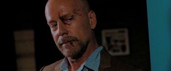 Movie still from “Surrogates” (2009), directed by Jonathan Mostow – A man with a shaved head and a shaved head with a shaved head; Close Up shot, Over the shoulder angle