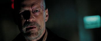 Movie still from “Surrogates” (2009), directed by Jonathan Mostow – A person with a black shirt on; Close Up shot, Over the shoulder angle