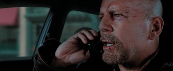 Movie still from “Surrogates” (2009), directed by Jonathan Mostow – A person talking on a cell phone; Close Up shot, Over the shoulder angle