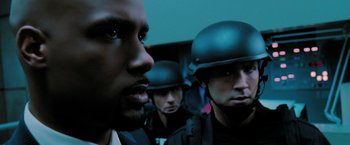 Movie still from “Surrogates” (2009), directed by Jonathan Mostow – A group of men wearing helmets and looking into the distance; Close Up shot, Over the shoulder angle