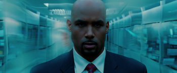 Movie still from “Surrogates” (2009), directed by Jonathan Mostow – A man in a suit and tie in a hallway; Close Up shot, Low angle