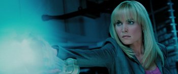 Movie still from “Surrogates” (2009), directed by Jonathan Mostow – A woman holding a remote control in her hand; Close Up shot, Low angle