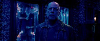 Movie still from “Surrogates” (2009), directed by Jonathan Mostow – A man with a bald head wearing a leather jacket; Medium shot, Over the shoulder angle