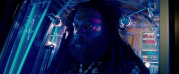 Movie still from “Surrogates” (2009), directed by Jonathan Mostow – A man with dreads and a beard is looking into the camera; Close Up shot, Low angle