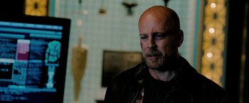 Movie still from “Surrogates” (2009), directed by Jonathan Mostow – A man with a shaved head is looking into the distance; Close Up shot, Over the shoulder angle