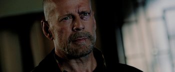 Movie still from “Surrogates” (2009), directed by Jonathan Mostow – A man with a beard and a black shirt is looking into the distance; Close Up shot, Low angle