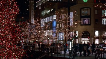 Movie still from “Surviving Christmas” (2004), directed by Mike Mitchell – People are walking down the street at night; Extreme Wide shot, High angle