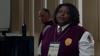 Movie still from “Surviving Christmas” (2004), directed by Mike Mitchell – A woman in a purple sweater is standing in front of a computer; Medium shot, Over the shoulder angle