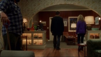 Movie still from “Surviving Christmas” (2004), directed by Mike Mitchell – A man standing in front of an open doorway; Wide shot, Over the shoulder angle