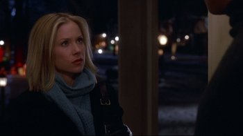 Movie still from “Surviving Christmas” (2004), directed by Mike Mitchell – A woman in a black jacket and a blue scarf; Close Up shot, Over the shoulder angle