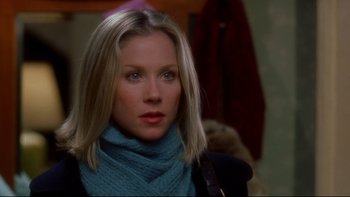 Movie still from “Surviving Christmas” (2004), directed by Mike Mitchell – A person wearing a blue scarf; Close Up shot, Over the shoulder angle